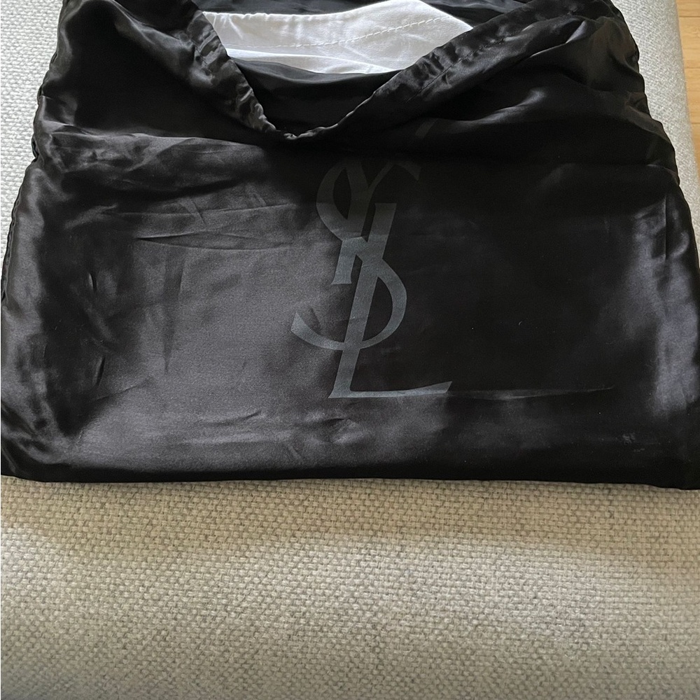 A brand new YSL clutch. It has a beautiful dark green leather.